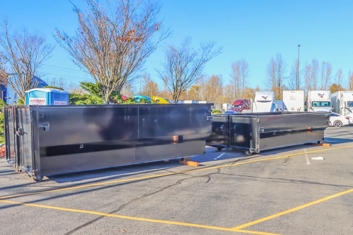 Professional dumpster rental service with roll-off container on residential driveway in Bullard